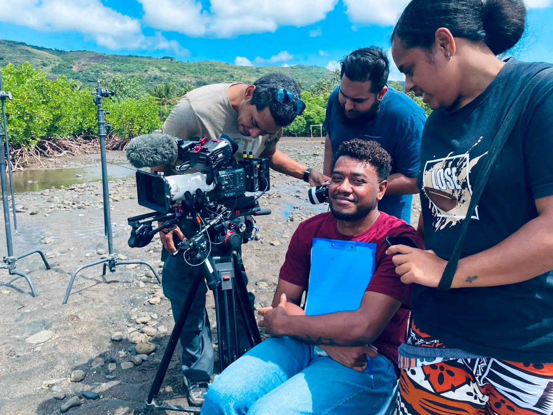 Film students and camera crew reviewing a shot