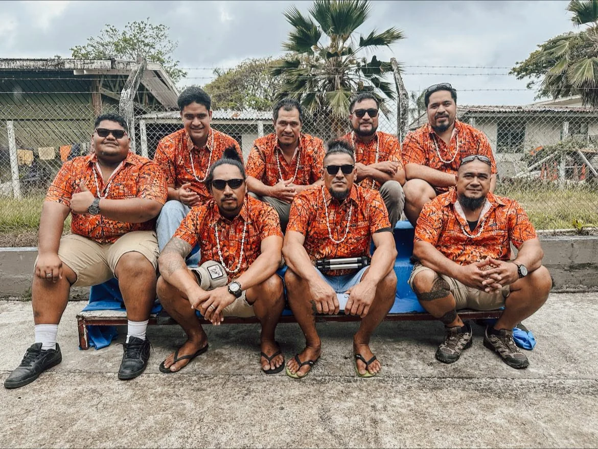 Sons of UK band portrait in coordinated orange shirts